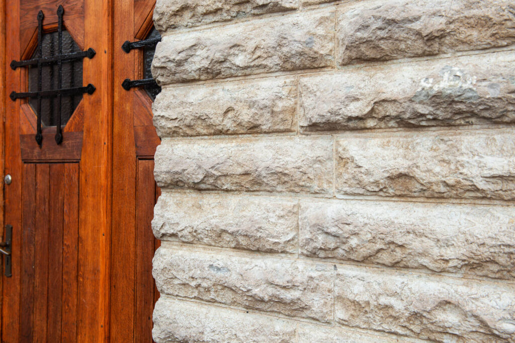 a facade of natural stone around windows and doors