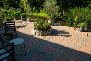 pattern laying of concrete paving stone in three different colors on a patio