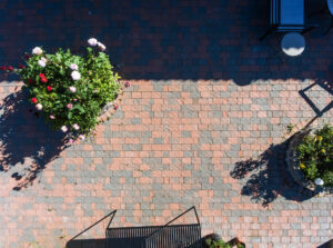 pattern laying of concrete paving stone in three different colors on a patio